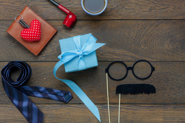 istock Table top view Happy Fathers day holiday background concept.Flat lay blue gift box for dad with accessories object sign of season on modern rustic brown wooden at home office desk.copy space design. 956100896