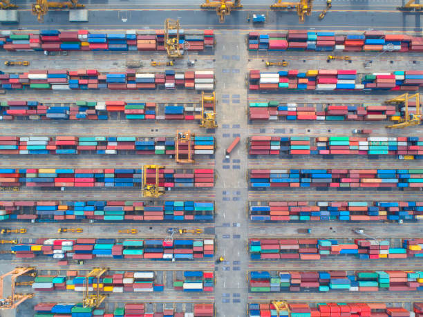 istock Container ship in export and import business and logistics. Shipping cargo to harbor by crane. Water transport International. Aerial view and top view 956101518