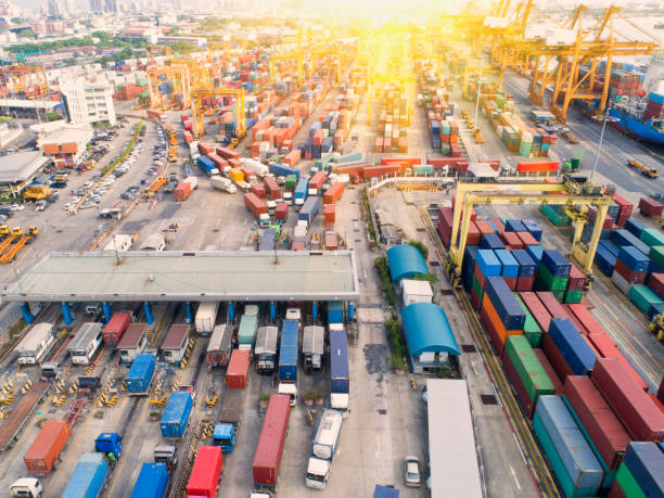 istock Container ship in export and import business and logistics. Shipping cargo to harbor by crane. Water transport International. Aerial view and top view 956101546