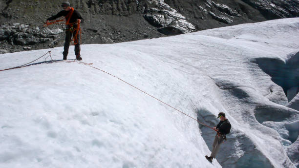 istock two mountain climbers during a crevasse rescue exercise 956104610