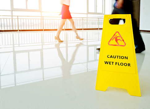 wet floor sign, cleaning in progress sign on wet floor.