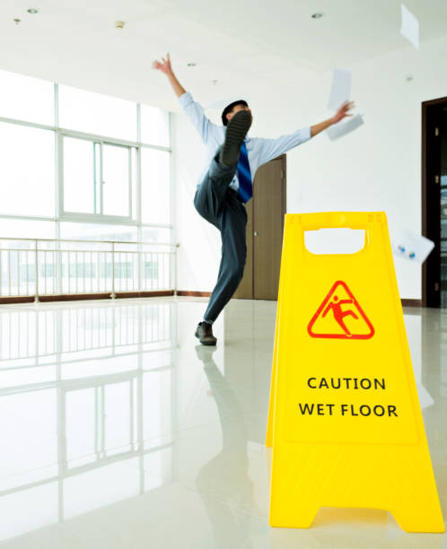 istock Businessman slipping on wet floor 956105380