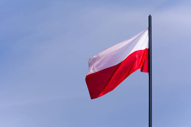 istock Polish flag on the sky background 956105684