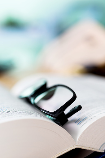 Close up glasses and open book on the table