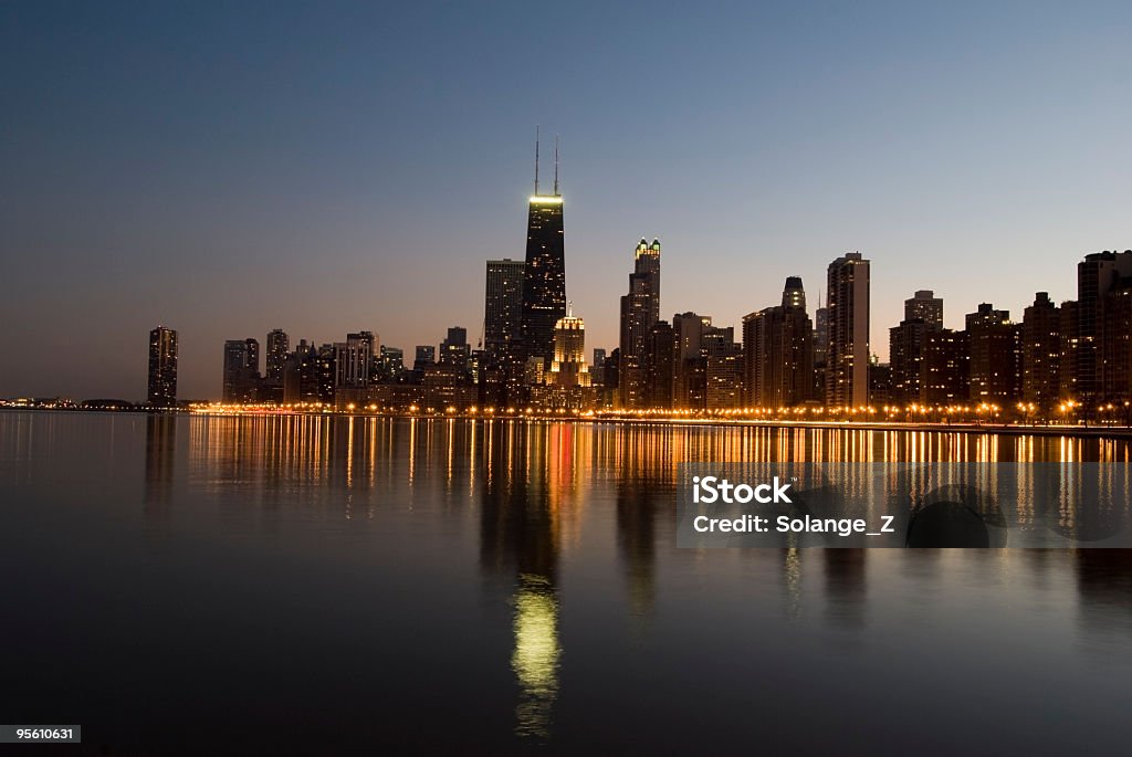 Chicago skyline reflected on Lake Michigan at sunset  Architecture Stock Photo