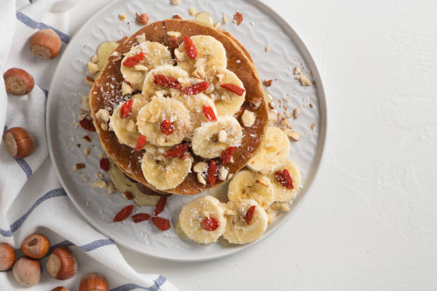 istock Pancakes with banana, walnuts, goji and honey 956110538