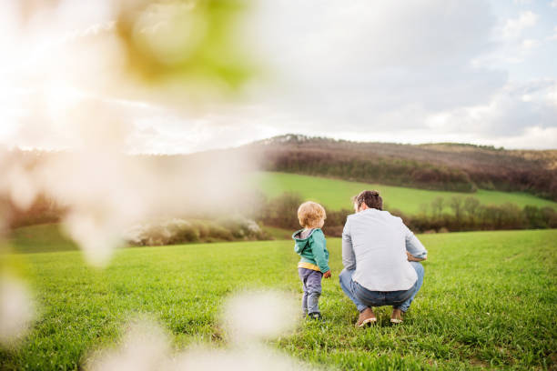 istock A father with his toddler son outside in spring nature. 956111208