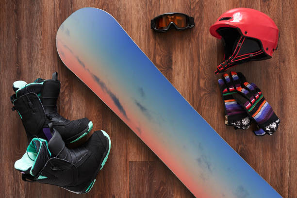 set of snowboard boots, helmet, gloves and mask on wooden - snowboard boot imagens e fotografias de stock