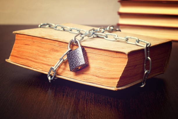 old book wrapped with chain and locked on padlock on table, concept, toned old book wrapped with chain and locked on padlock on table, concept, toned exclusion stock pictures, royalty-free photos & images