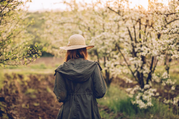 istock Girl walking in orchard 956119040