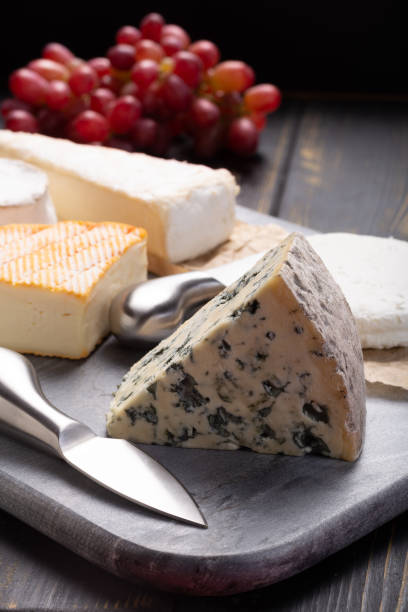 istock French cheeses plate in assortment, blue cheese, brie, munster, soft goat cheese, Neufchatel 956120488