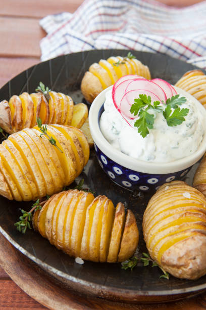Rustic hasselback potatoes Rustic hasselback potatoes with fresh thyme and sea salt baked potato sour cream stock pictures, royalty-free photos & images