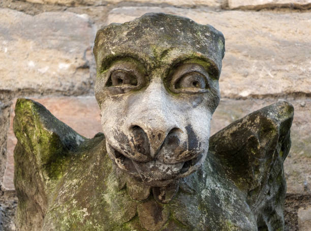 istock medieval gargoyle grotesque face on stone church wall 956122924