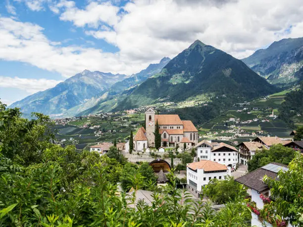 Picturesque elevated view to Scena, Merano - Italy, with the Church of the Assumption of St. Mary