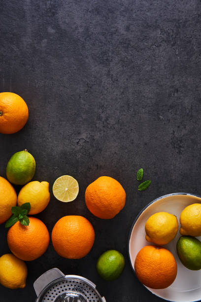 istock Juice preparation. Fresh ripe citruses on dark background. 956130700