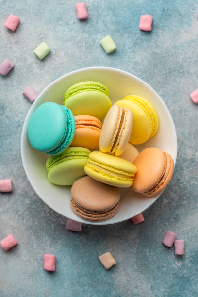 istock Colorful cookies macarons on the plate and airy marshmallows 956131096