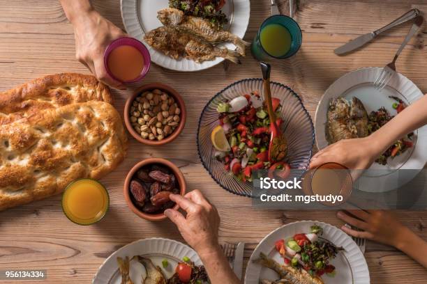 Family Ready For İftar Meal In Ramadan Stock Photo - Download Image Now - Ramadan, Suhur, Fasting - Activity