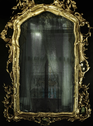 Abstract gothic stylised image of reflections in an ornate golden baroque mirror