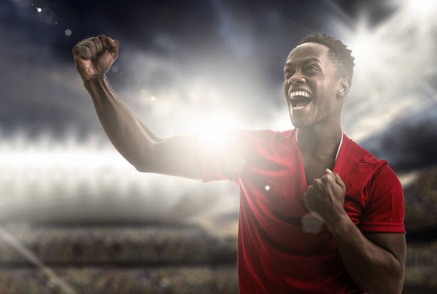 istock Afro young man fan celebrating in the stadium 956140376