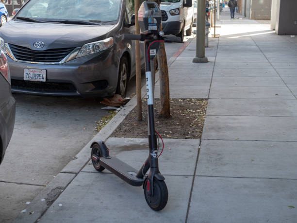 Bird, transportation start up, electric scouter parked on sidewalk SAN FRANCISCO, CA – APRIL 22, 2018: Bird, transportation start up, electric scouter parked on sidewalk lime scooter stock pictures, royalty-free photos & images