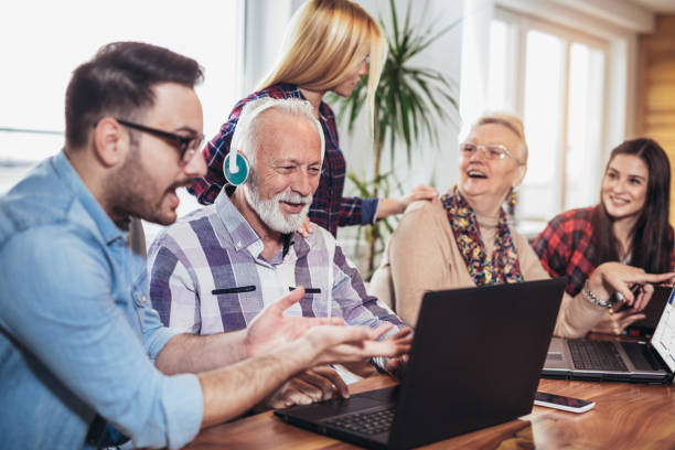 istock Young volunteers help senior people on the computer 956152848