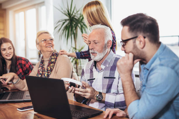 istock Young volunteers help senior people on the computer 956153244