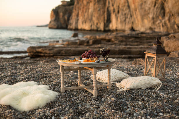 istock romantic dinner with wine and grapes by seaside 956156938