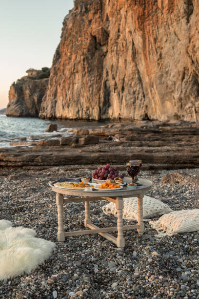 istock romantic dinner with wine and grapes by seaside 956156942