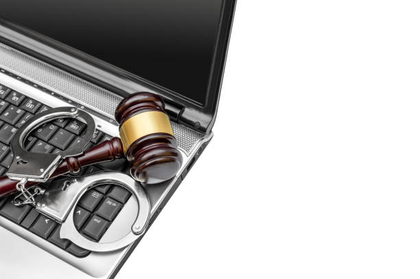 istock Laptop with handcuffs and gavel. Isolated on white. Copy space. 956157944