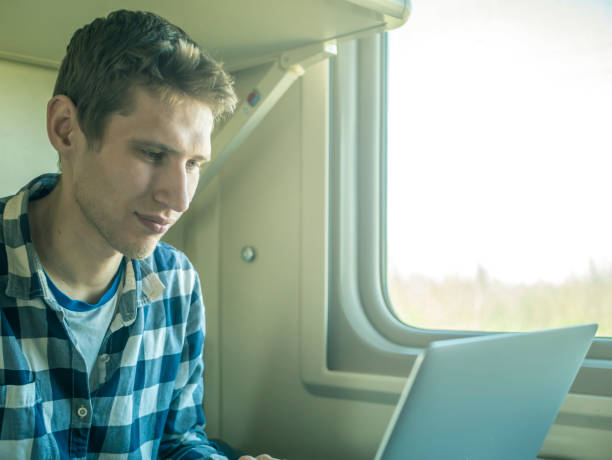 istock young man sitting near the window at the table while journey by train 956157946