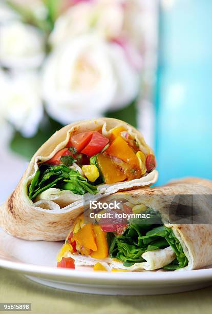 A Vegetable Wrap Cut In Half On A Plate Stock Photo - Download Image Now - Vegetable, Wrap Sandwich, Bread