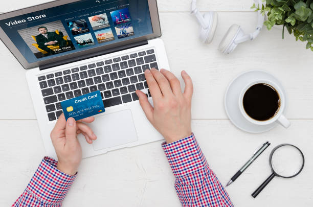istock Man using credit card to pay for Video On Demand service 956161134