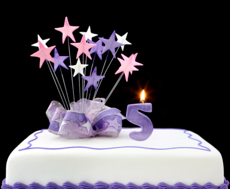 Birthday cake with pink cream and happy birthday decoration