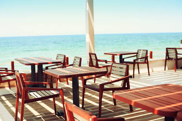 istock Tables and chairs at outdoor restaurant on the beach 956162142