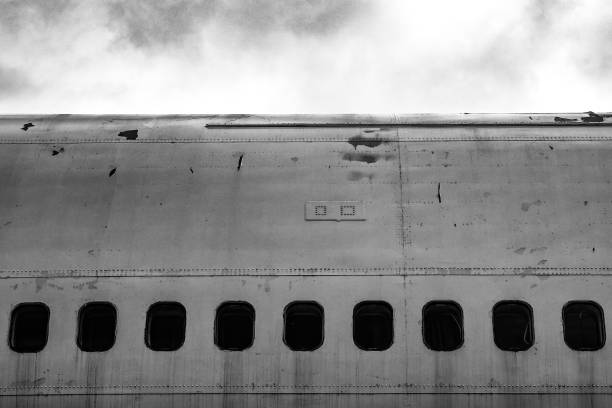 Dystopic image of the cabin windows on an old abandoned jet plane / aircraft. Concept of fear of flying or flying / aero phobia.