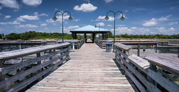 A fishing pier with a shady pavilion at Sunset Point, a public park in Mandeville, Louisiana.