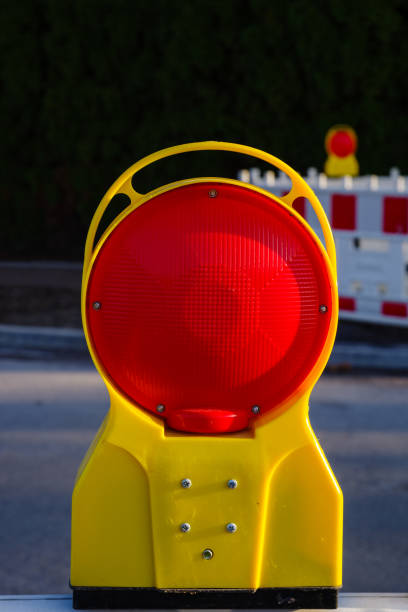Red warning light of a construction site on the street in Germany
