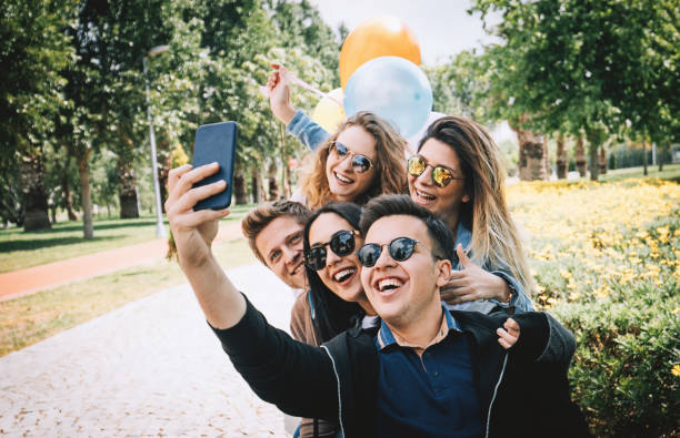 istock Best friends having fun and taking selfie at park 956168132