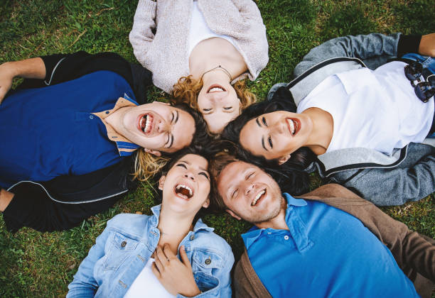 istock Happiness young friends lying down in the grass outside 956168184