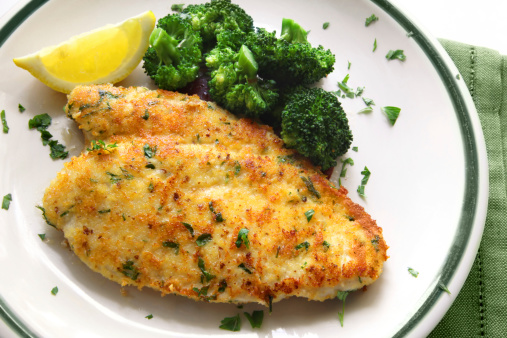 Breaded and herbed chicken breast fillet, served with broccoli and lemon.  Delicious chicken schnitzel.  More chicken images: