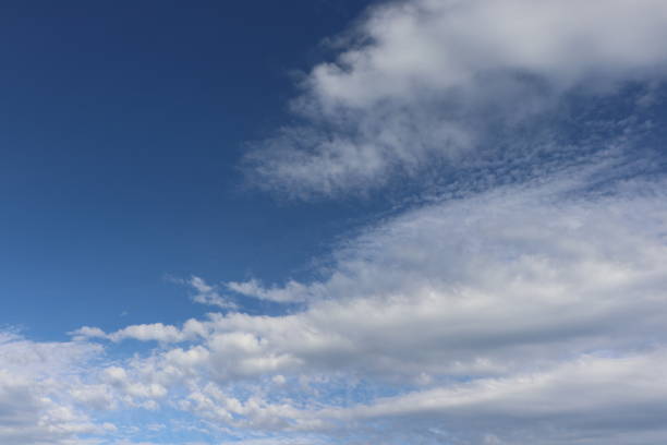 istock Close up of fluffy white clouds against blue sky with copy space 956171298