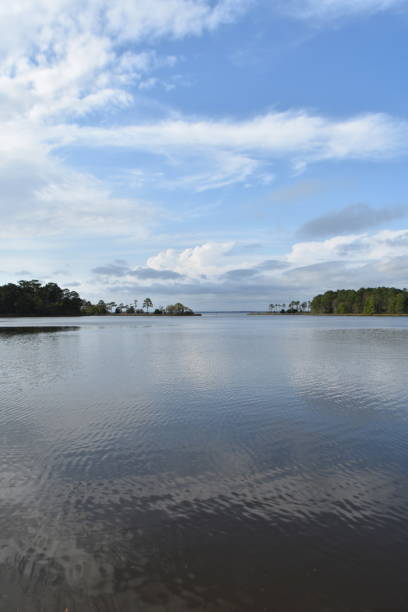 istock Blue sky reflects on bay inlet 956172094