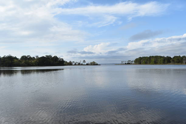 istock Blue sky reflects on bay inlet 956172150