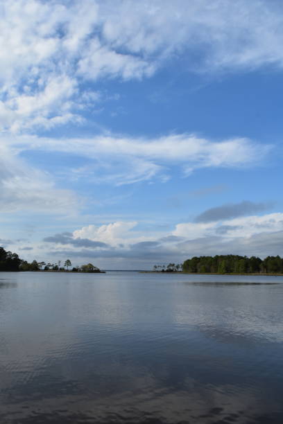 istock Blue sky reflects on bay inlet 956172180