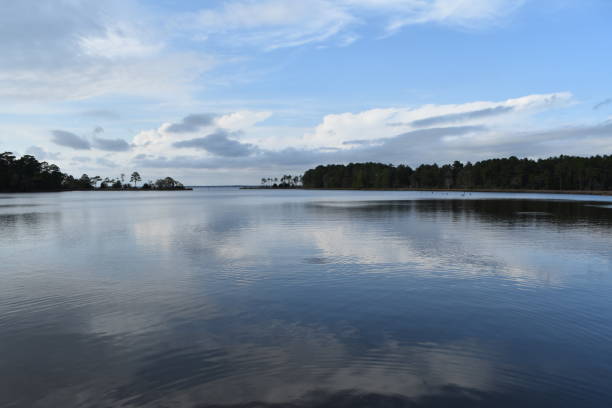 istock Blue sky reflects on bay inlet 956172184