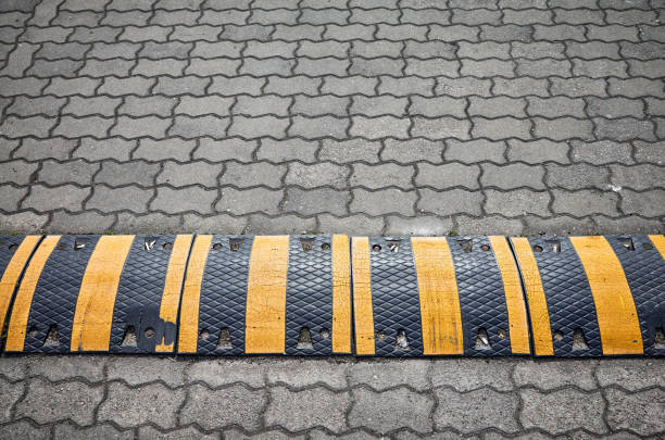 Speed bump on a paved road, selective focus.