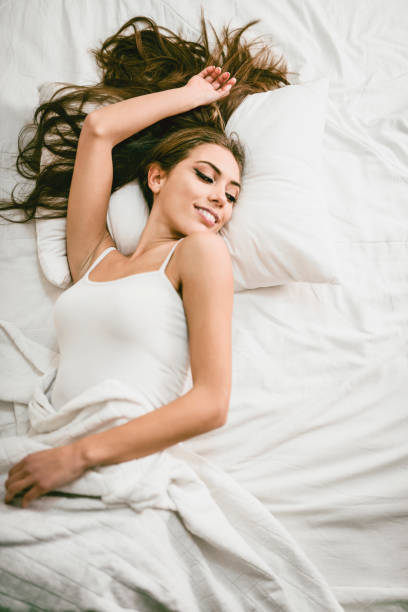 istock Young Smiling Female Lying and Waking up in her Bedroom 956177152