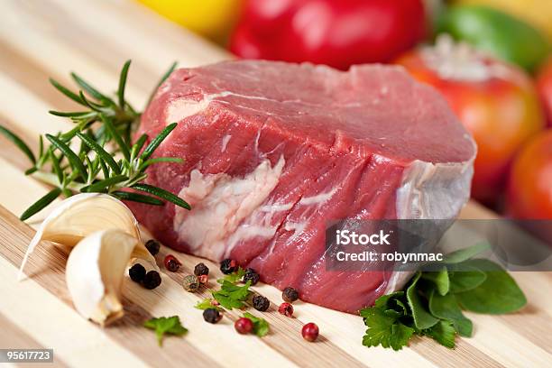 Raw Fillet Steak With Garlic Herbs And Spices On A Board Stock Photo - Download Image Now