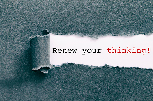 Renew your thinking written under torn paper.