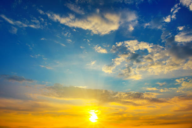istock Cloudy sky and bright sunrise over the horizon. 956184006